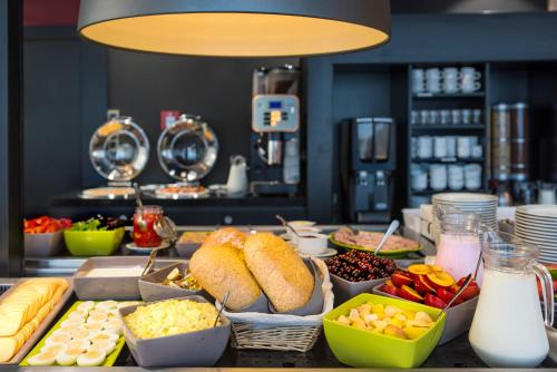 a buffet with different types of food on a table at Campanile Wroclaw - Stare Miasto in Wrocław