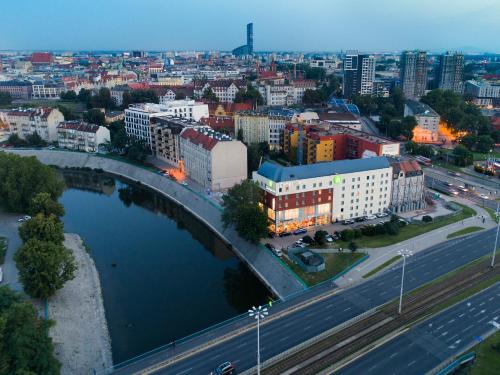 an aerial view of a city with a bridge and a river at Campanile Wroclaw - Stare Miasto in Wrocław