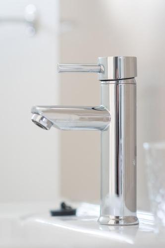 a silver faucet on a white sink at Westwood Skye 12 Grace Avenue in Durban