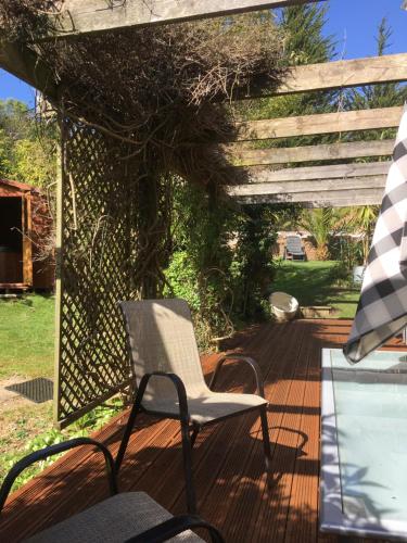 a chair sitting on a deck with a pergola at Ralph's Barn in Newport