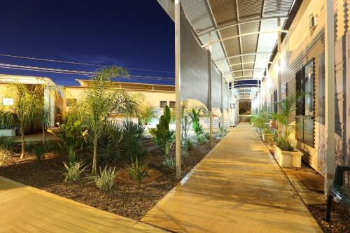 a hallway of a building with plants on it at Mia Mia House in the Desert in Newman