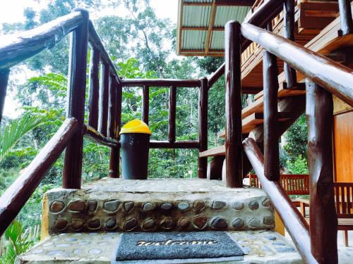 a playground with a wooden stairway with a yellow top at Victordelia Hilltop Hostel in San Vicente