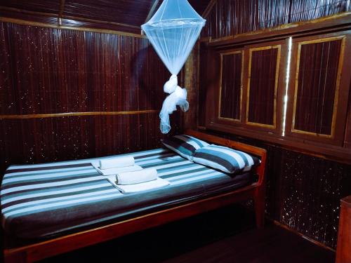a bench in a room with a umbrella on it at Victordelia Hilltop Hostel in San Vicente