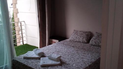 a small bedroom with a bed with towels on it at Aqua Royal Alexus Luxury Holiday Apartments Girne in Kérynia