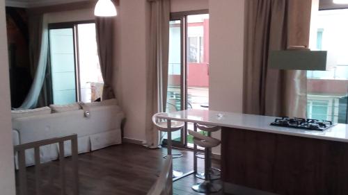 a kitchen and living room with a table and a couch at Aqua Royal Alexus Luxury Holiday Apartments Girne in Kérynia