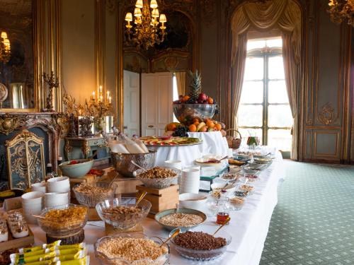 a table filled with lots of different types of cakes at Cliveden House in Taplow
