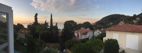 a view of a city with houses and trees at Villa Mirano in Èze