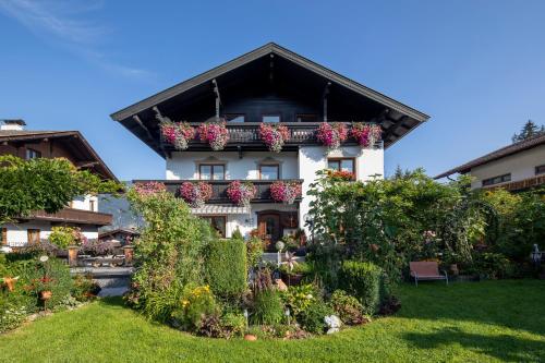 a house with flower boxes on the balcony at Haus Konrad in Reith im Alpbachtal