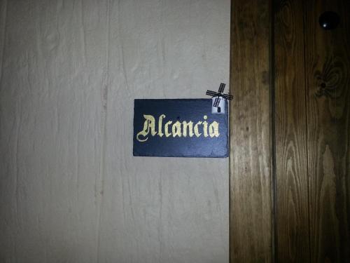 a sign that reads alaminaria hanging on a wall at Posada de los Cónsules in Consuegra