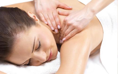 a woman getting a massage from a therapist at Camela Hotel & Resort in Hai Phong