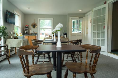 a dining room with a table and chairs at The Lodge at West River in Newfane