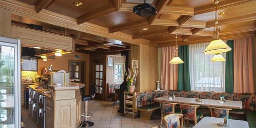 a kitchen with two sinks and a counter in a room at Café Landerl in Matrei in Osttirol