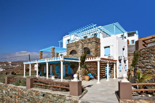 a house with a blue and white at Grand View Tinos in Tinos