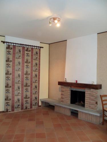 a living room with a fireplace and a screen at Appartamento San Bastian in CastellʼAlfero