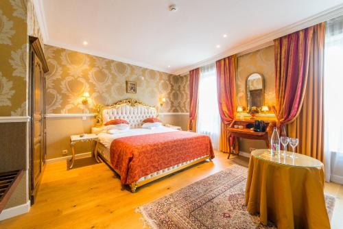 a bedroom with a large bed and a large window at Boutique Hotel Die Swaene in Bruges