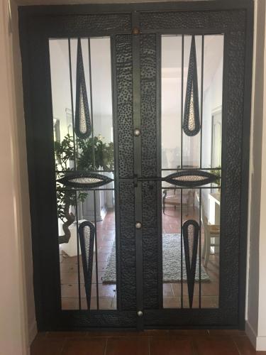 a glass door with a table and chairs in a room at La Chaumeauniere in Aigrefeuille-dʼAunis