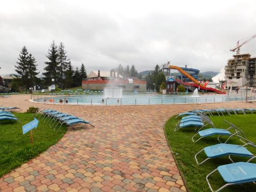 a group of blue chairs and a water park at Wellness Hotel Bešeňová in Bešeňová