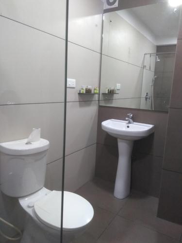 a bathroom with a toilet and a sink at Grand Plaza in Munnar