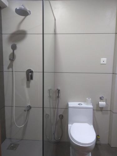 a bathroom with a toilet and a shower at Grand Plaza in Munnar