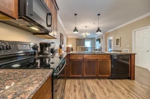 a large kitchen with wooden cabinets and a stove top oven at Holiday Inn Club Vacations Williamsburg Resort in Williamsburg