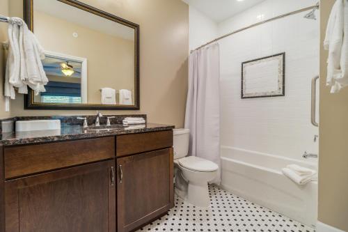 a bathroom with a sink and a toilet and a tub at Holiday Inn Club Vacations Williamsburg Resort in Williamsburg