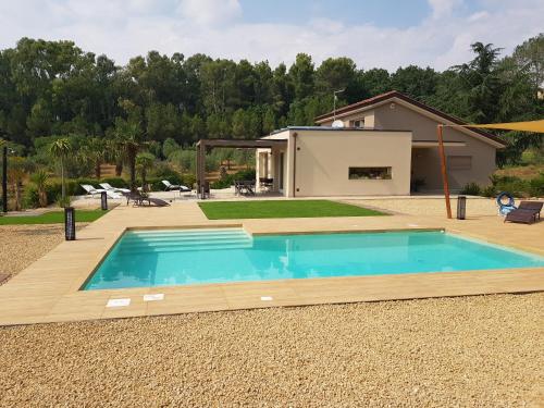 a swimming pool in a yard with a house at Folco Studio Apartment in Piazza Armerina