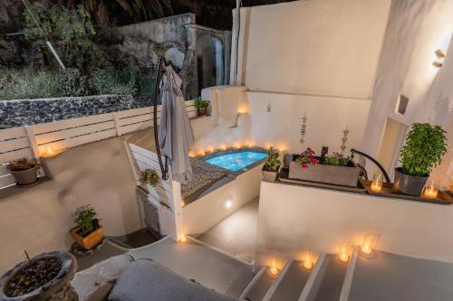 a patio with a swimming pool with candles and lights at Hidden Treasure Suites in Vóthon
