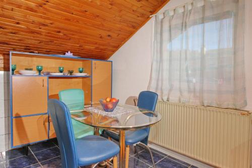 a dining room with a glass table and chairs at Vila As in Zlatibor