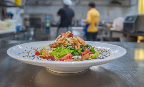 a white plate of food on a table at Hotel Restaurant Dreri in Tirana