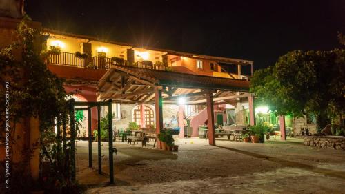 a night view of a building with a balcony at Agriturismo Costiolu in Nuoro