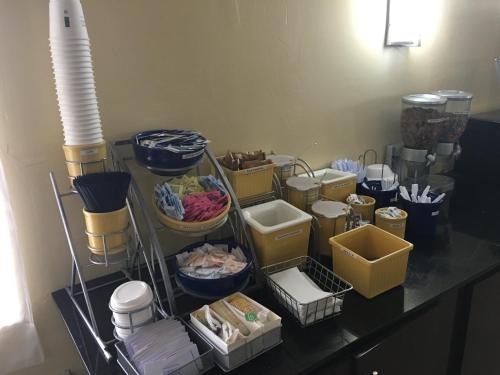 a counter with a bunch of bowls and other items at Days Inn by Wyndham Eufaula AL in Eufaula