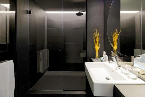 a bathroom with a sink and a shower at H10 Port Vell 4* Sup in Barcelona