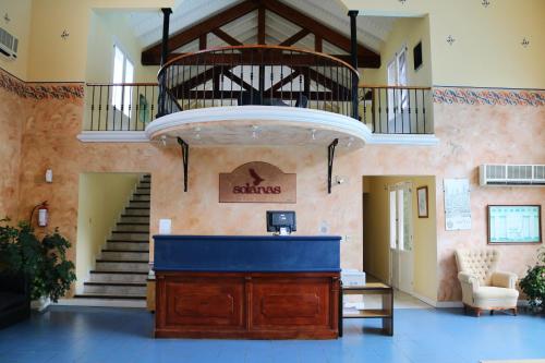 a lobby with a podium and stairs in a building at Solanas Termas de Dayman in Termas del Daymán