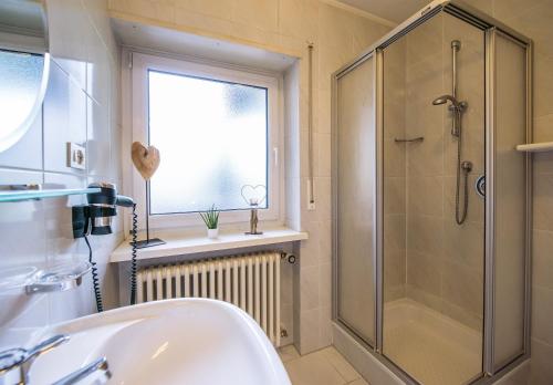 a bathroom with a shower and a sink at Vitaurina Royal Hotel in Molini di Tures