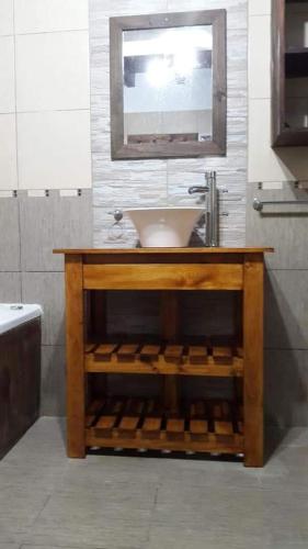 a bathroom with a sink and a mirror at cascada del bosque in Mar de las Pampas