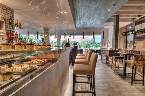a restaurant with a bar with bar stools at Esplanade Tergesteo - Luxury Retreat in Montegrotto Terme
