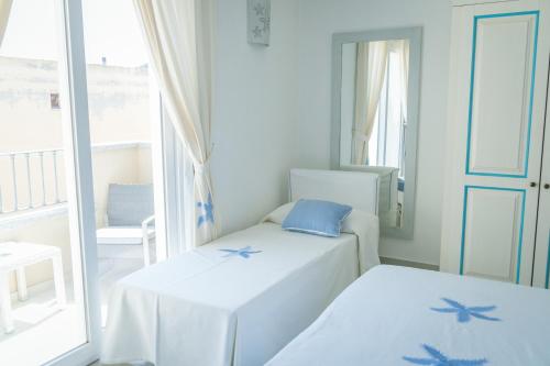 Postel nebo postele na pokoji v ubytování Hotel Regina Simius