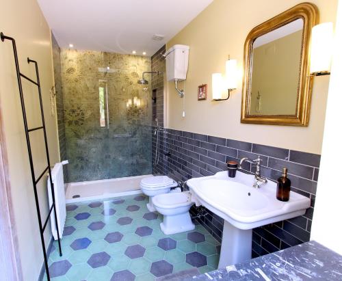 a bathroom with a toilet and a sink and a shower at Al 33 Giri in Cefalù
