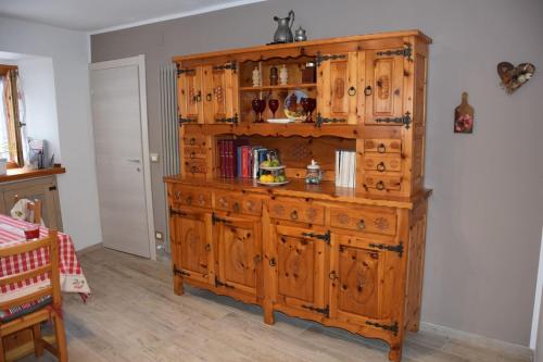 a large wooden cabinet in a room at Chez Elida in Saint-Christophe