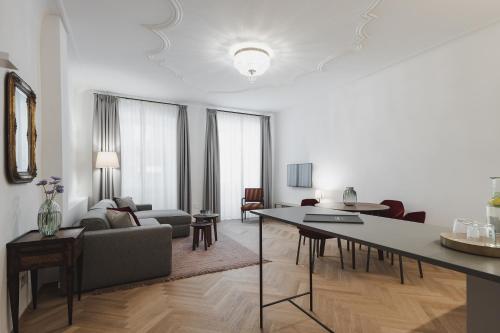a living room with a couch and a table at Kuntino Suites in Merano