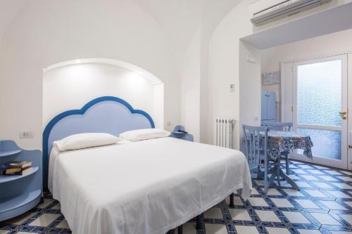 una camera con un letto blu e bianco e un tavolo di Villa Elisa Holiday Home a Sorrento