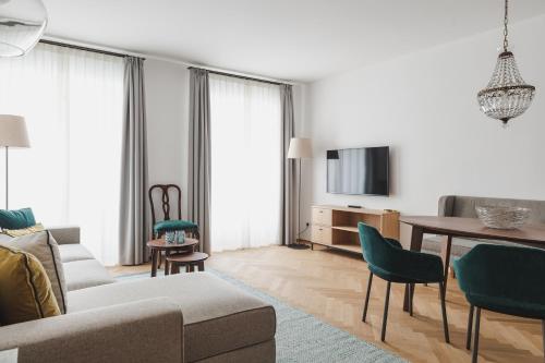 a living room with a couch and a table at Kuntino Suites in Merano