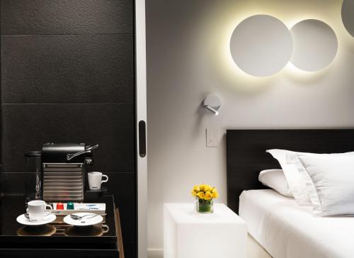a bedroom with a bed and a table with a coffee maker at H10 Port Vell 4* Sup in Barcelona