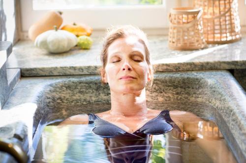 a woman in a swimming pool with pumpkins at Château De Riell in Molitg les Bains