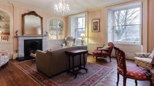 a living room with a couch and a fireplace at The Orchard House in Rothbury