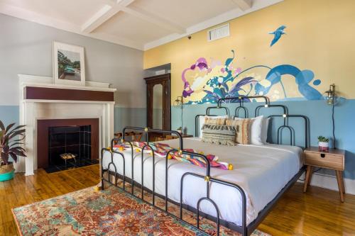 a bedroom with a bed with a painting on the wall at Selina Miami River in Miami