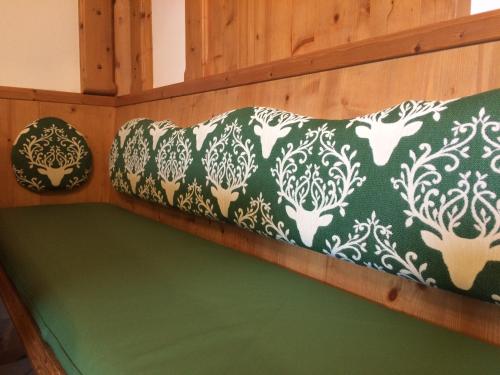 a green and white couch in a room at Alpin Chic in Grödig