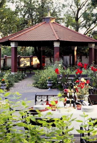 a picnic table in front of a gazebo at Hotel Aleksander in Włocławek