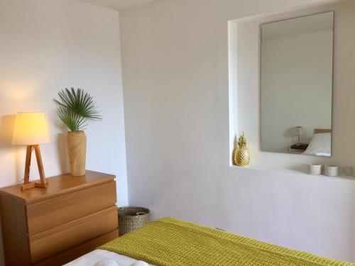 a bedroom with a bed and a dresser with a mirror at Calanque in Cassis