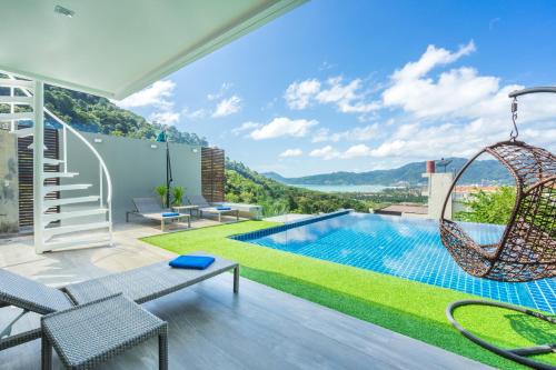 a villa with a swing and a swimming pool at Sirirat Sea-view Villa in Patong Beach